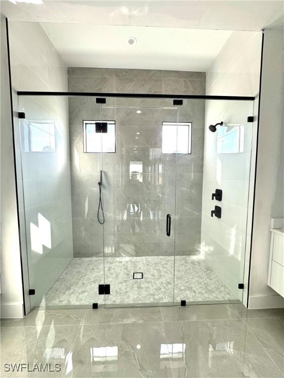 bathroom featuring an enclosed shower and vanity