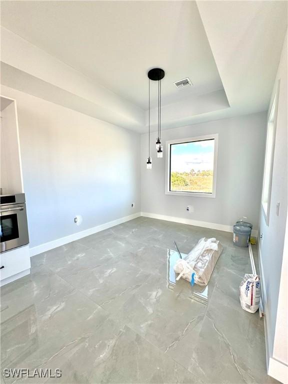 interior space with a raised ceiling