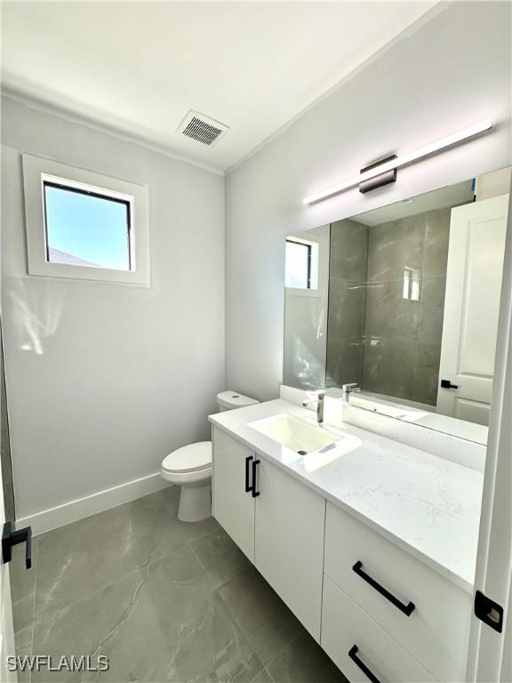 bathroom featuring vanity and toilet