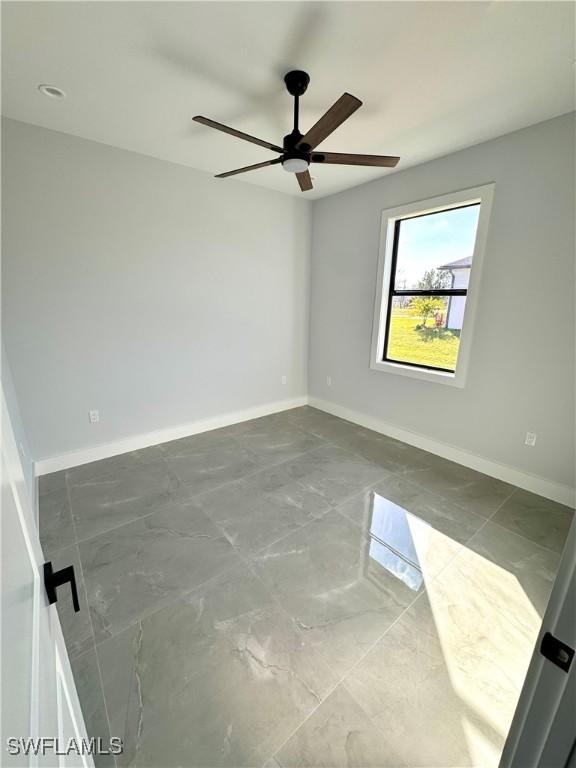 unfurnished room featuring ceiling fan