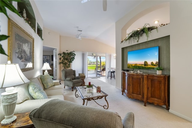 living room featuring vaulted ceiling, ceiling fan, and light colored carpet