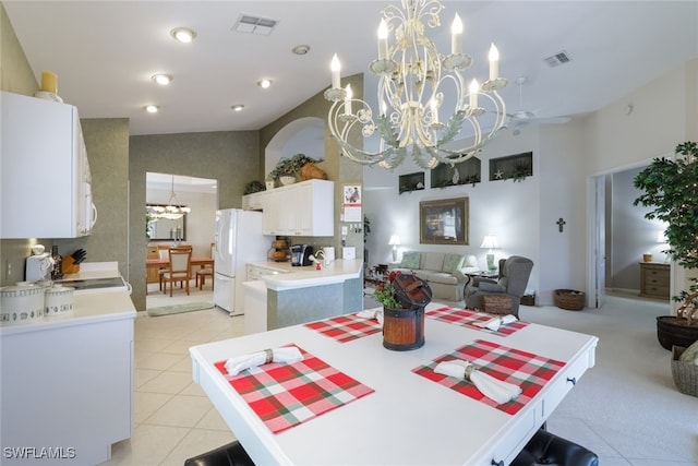 dining area featuring light tile patterned floors, high vaulted ceiling, and a chandelier