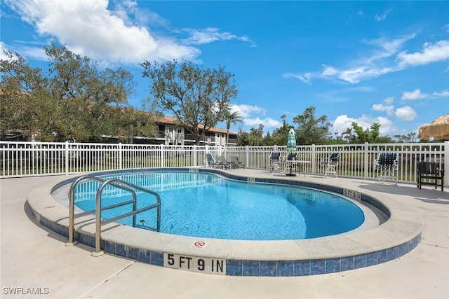 pool featuring a patio area and fence