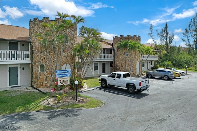 view of building exterior featuring uncovered parking