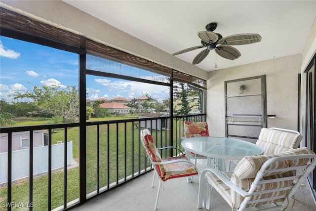 sunroom / solarium with a ceiling fan