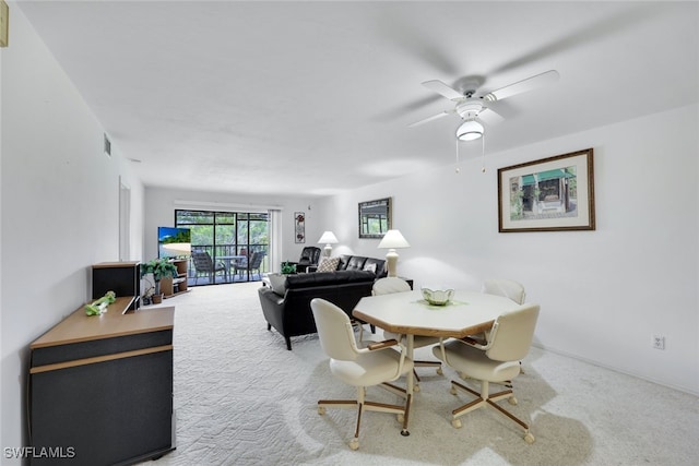 dining area featuring carpet floors, visible vents, and ceiling fan