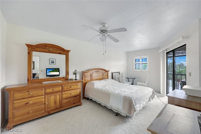 bedroom with a ceiling fan, light colored carpet, and access to exterior