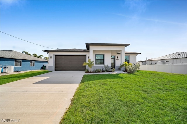 view of front of house featuring a garage and a front yard