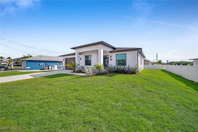 view of front of house with a garage and a front yard