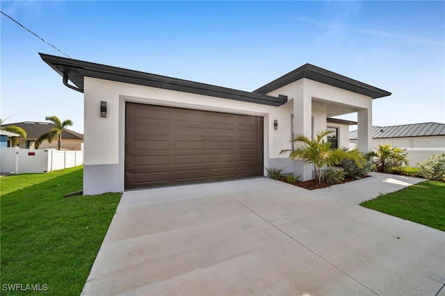 contemporary home featuring a garage and a front lawn