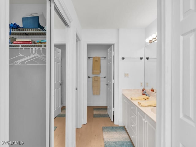 bathroom featuring vanity and wood-type flooring