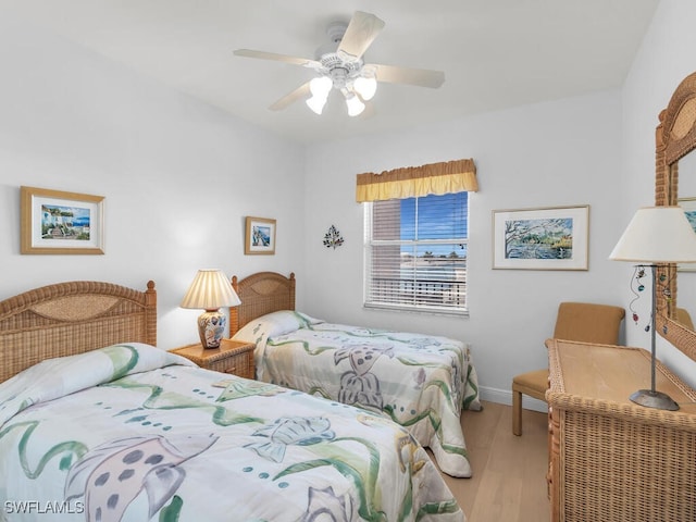 bedroom with light hardwood / wood-style floors and ceiling fan