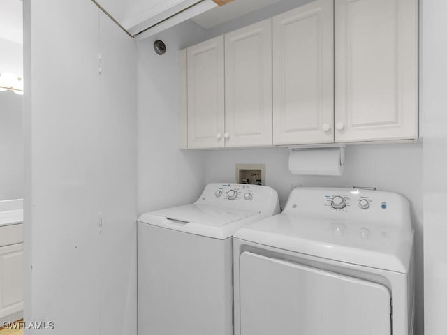 washroom with cabinets and separate washer and dryer