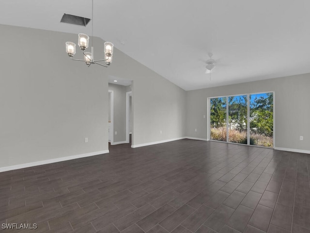 unfurnished room with vaulted ceiling, dark hardwood / wood-style floors, and ceiling fan with notable chandelier