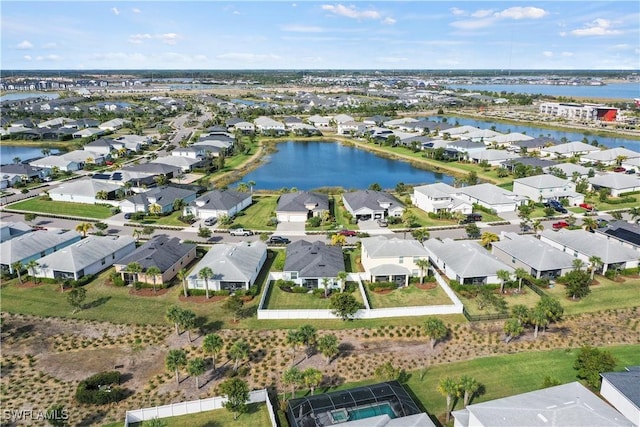 drone / aerial view with a residential view and a water view