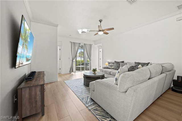 living room with crown molding, ceiling fan, and light hardwood / wood-style floors