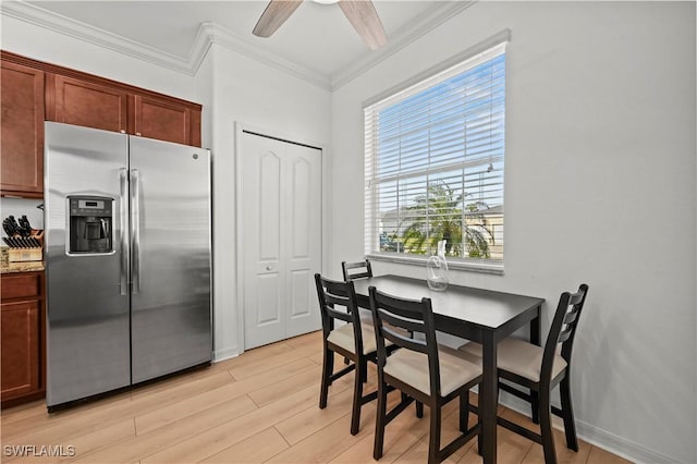 dining space featuring ornamental molding, ceiling fan, and light hardwood / wood-style flooring