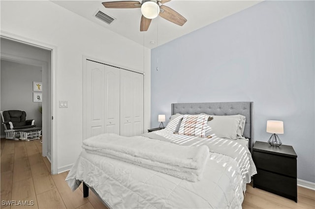 bedroom with ceiling fan, a closet, and light hardwood / wood-style flooring