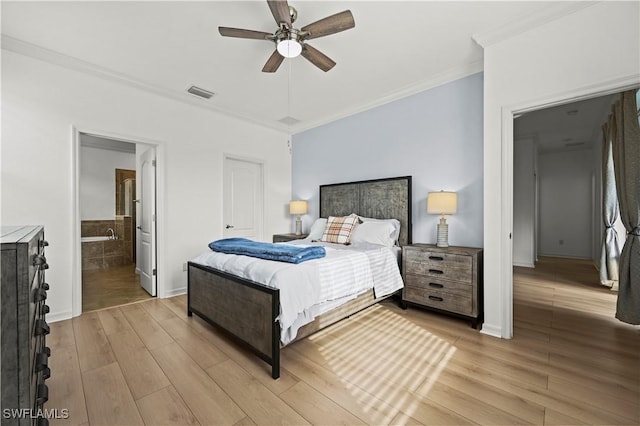 bedroom with ornamental molding, ensuite bathroom, ceiling fan, and light wood-type flooring