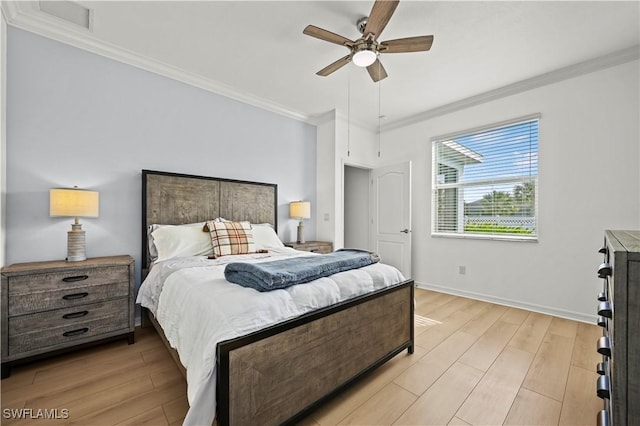 bedroom featuring light wood finished floors, ceiling fan, crown molding, and baseboards