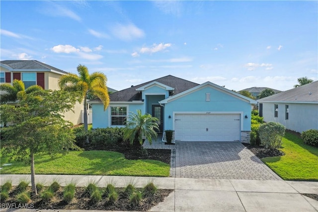 single story home featuring a front yard, decorative driveway, a garage, and stucco siding