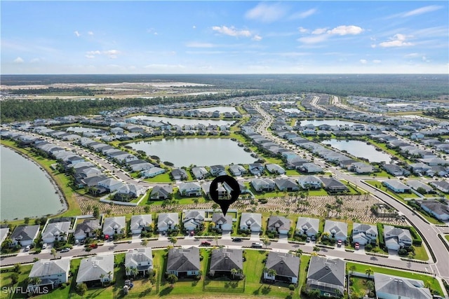 drone / aerial view with a water view and a residential view