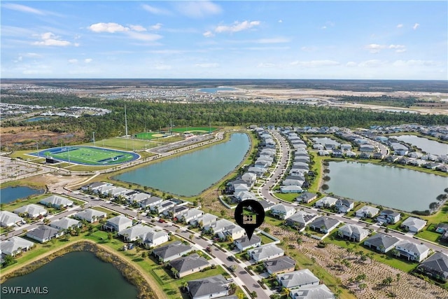 drone / aerial view featuring a residential view and a water view