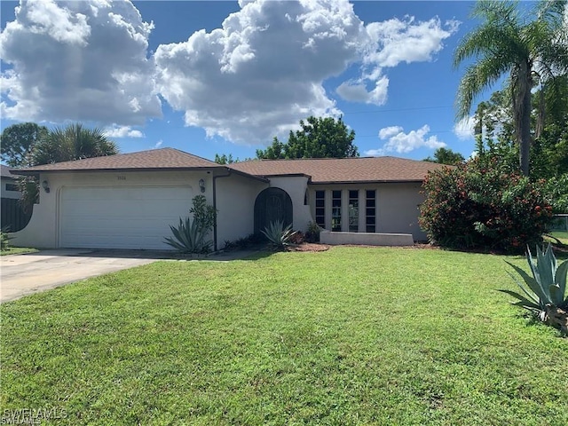 ranch-style home with a garage and a front yard