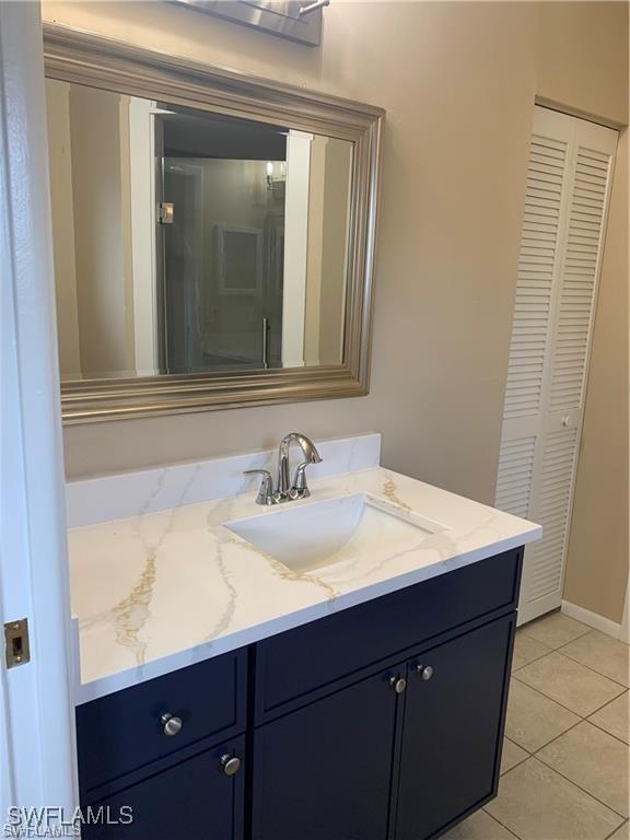 3926 Palm Tree Blvd, Cape Coral, FL 33904 - bathroom with vanity, a closet, and tile patterned flooring