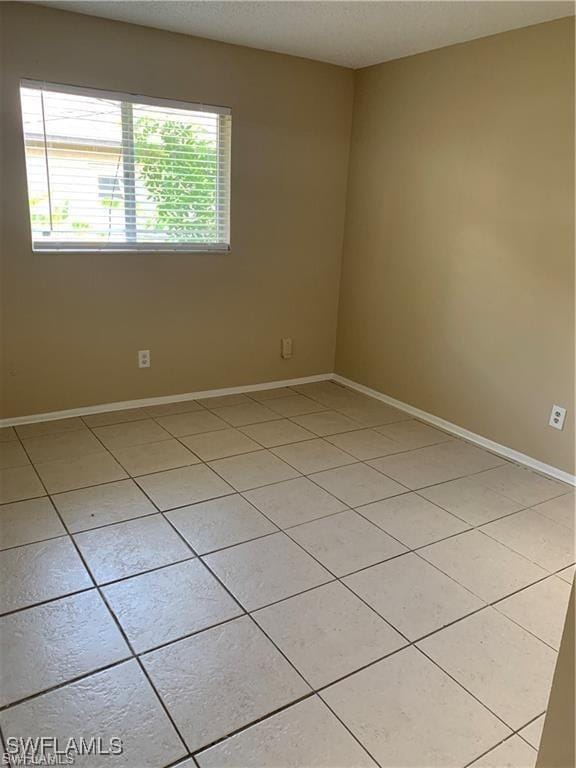 3926 Palm Tree Blvd, Cape Coral, FL 33904 - unfurnished room with light tile patterned floors and baseboards