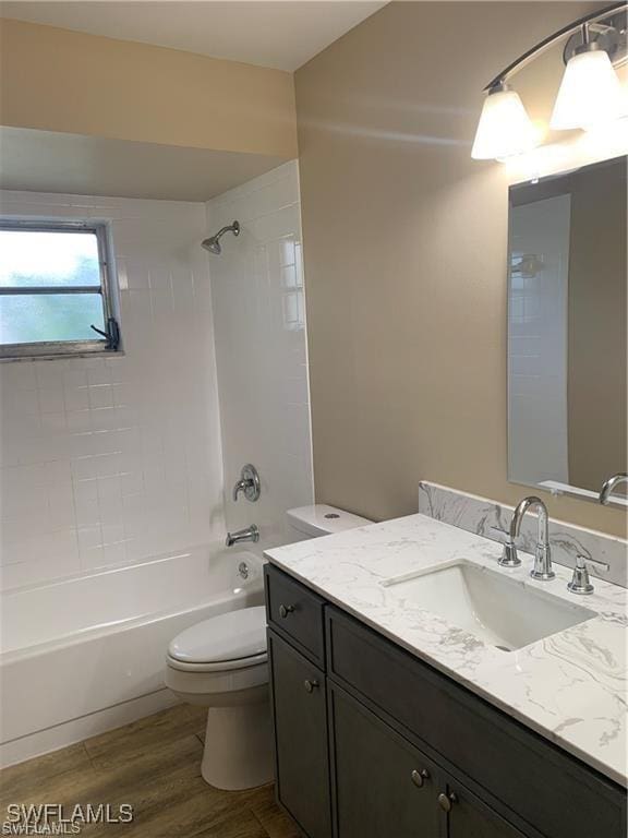 3926 Palm Tree Blvd, Cape Coral, FL 33904 - bathroom featuring vanity, wood finished floors, and shower / bath combination