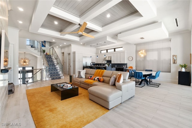 living room featuring beamed ceiling, coffered ceiling, and a chandelier