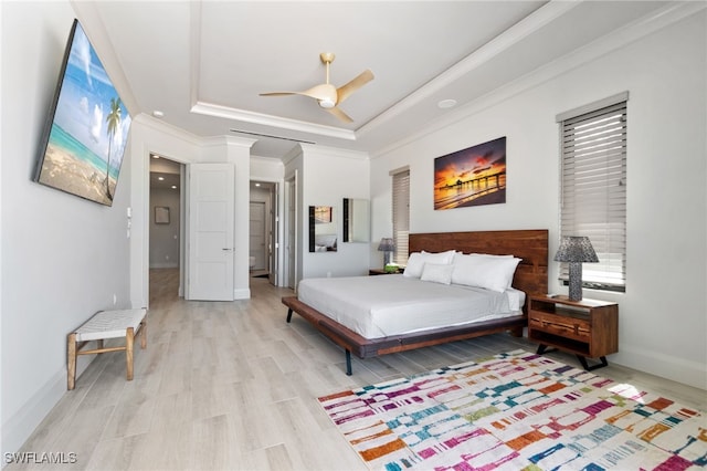 bedroom featuring crown molding, ceiling fan, baseboards, light wood-type flooring, and a raised ceiling