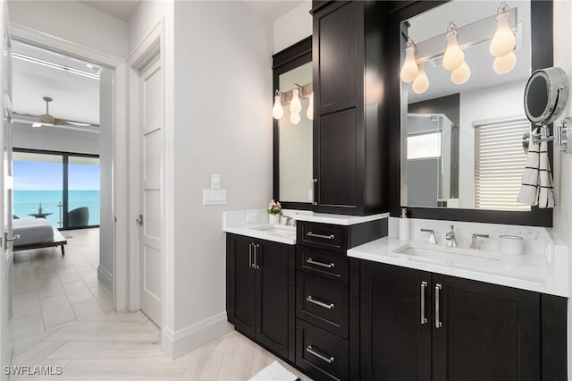 bathroom with vanity, a water view, and plenty of natural light