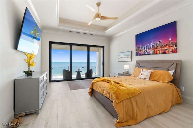 bedroom featuring access to exterior, baseboards, light wood-style floors, a raised ceiling, and a ceiling fan