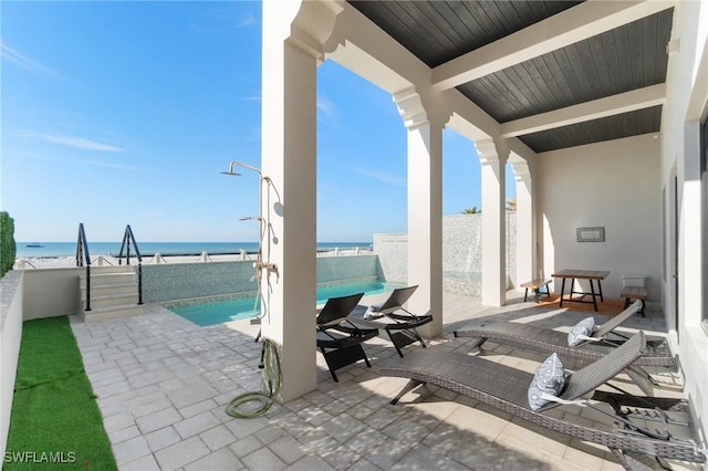 view of patio featuring a fenced in pool and a water view