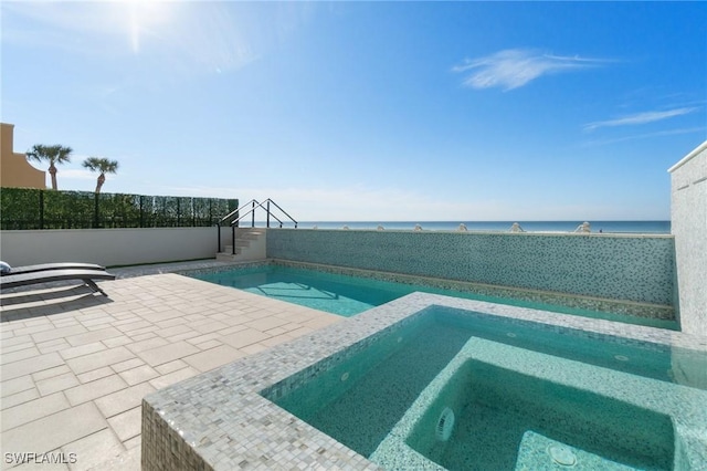 view of swimming pool with a patio, an in ground hot tub, and a water view