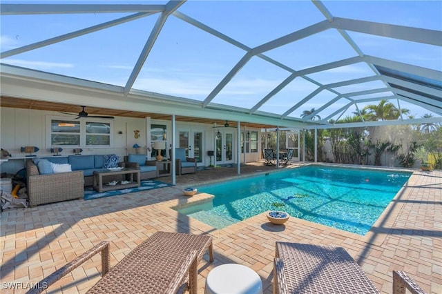 pool with french doors, an outdoor hangout area, a ceiling fan, a patio area, and a lanai