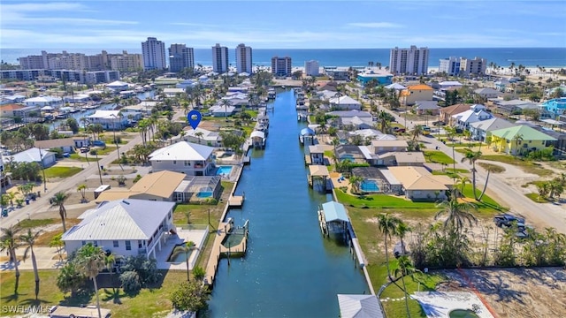 bird's eye view featuring a water view and a city view