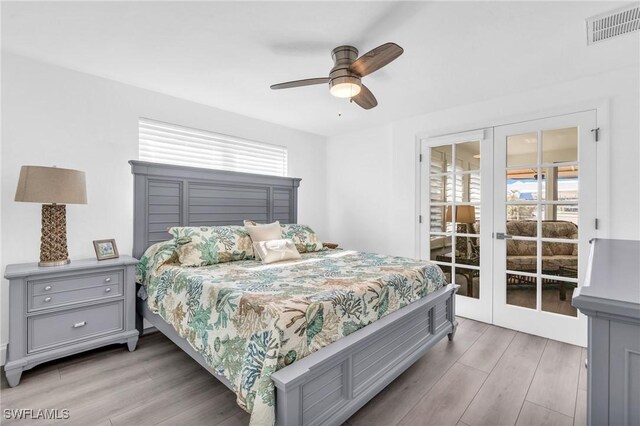 bedroom featuring french doors, ceiling fan, access to outside, and hardwood / wood-style flooring