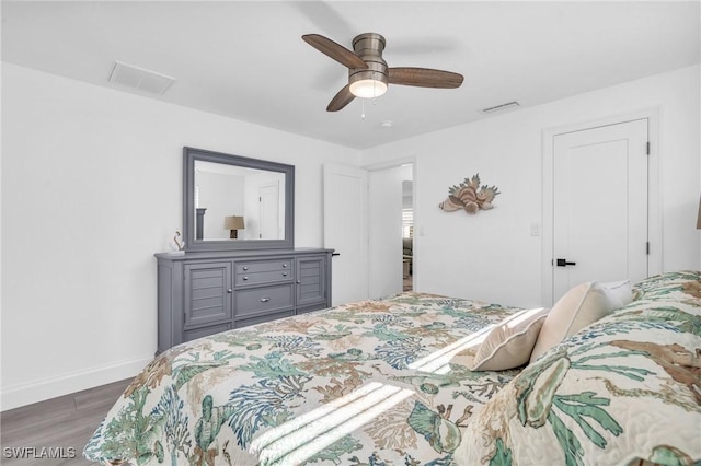 bedroom featuring a ceiling fan, baseboards, visible vents, and dark wood-style flooring