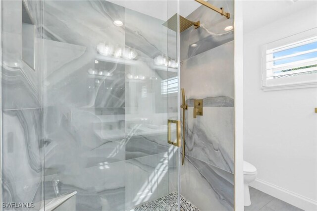 bathroom with tile patterned flooring, a shower with door, and toilet