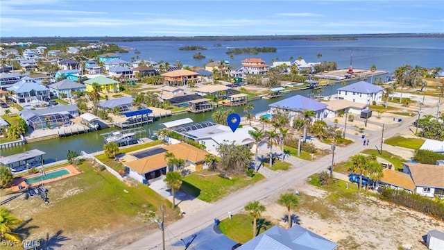 birds eye view of property with a water view and a residential view