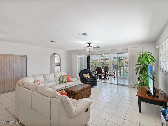 tiled living room featuring ceiling fan