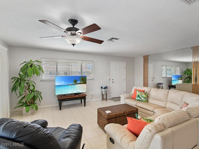 tiled living room with ceiling fan