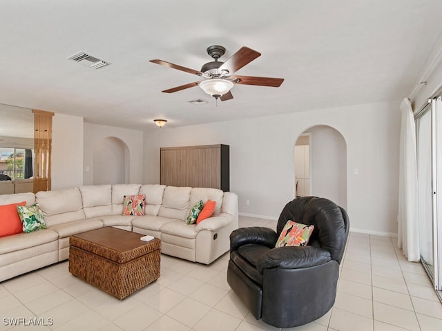 tiled living room with ceiling fan