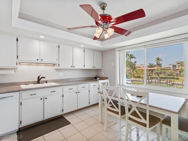 kitchen featuring sink, crown molding, dishwasher, white cabinetry, and a raised ceiling