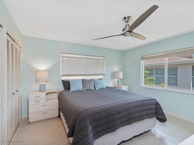 tiled bedroom with ceiling fan and a closet