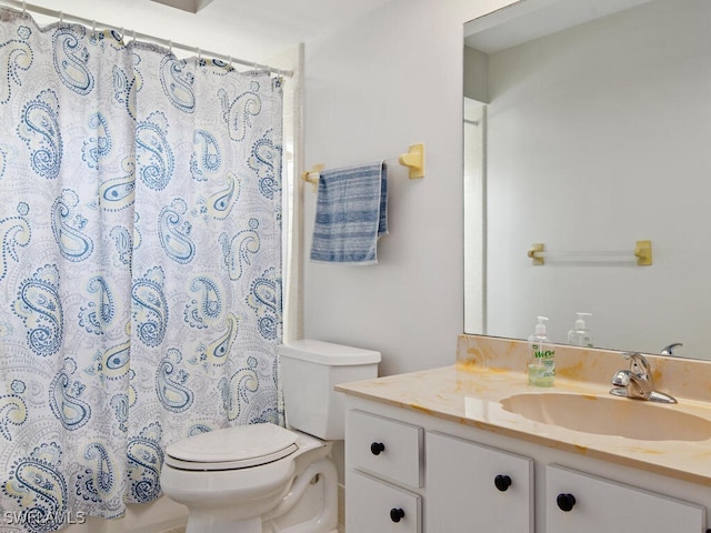 bathroom featuring vanity, walk in shower, and toilet