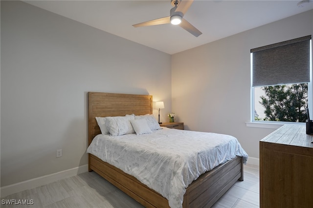 bedroom with light hardwood / wood-style flooring and ceiling fan